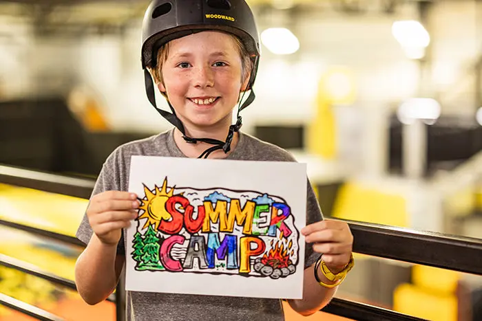 a skate camper holding up some art he created