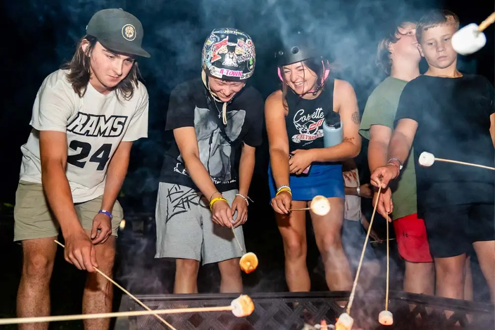 campers roasting marshmallows